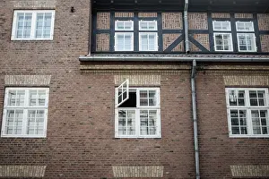 A traditional brick wall with multiple windows in an urban setting in Copenhagen
