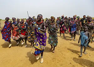 Traditional dressed women of the Jiye tribe dancing and singing
