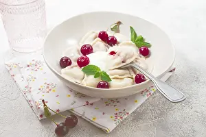 Traditional dumplings with cherries and yogurt