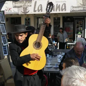 Traditional guitar player, singer in a restaurant