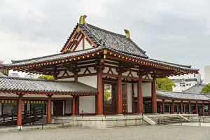 A traditional Japanese temple with red wood structure and curved roof