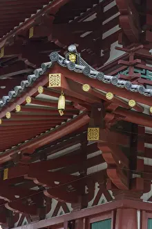 Detail of a traditional Japanese temple with red wooden beams and a lantern