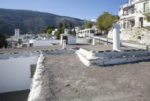 Traditional roofs and chimneys of houses in the village of Capileira