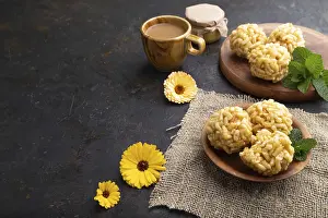 Traditional Tatar candy chak-chak made of dough and honey with cup of coffee on a black concrete background