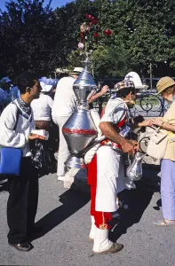 Traditional water carrier vendor with tourists in Istanbul, Turkey, 1997, Asia
