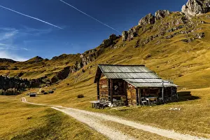 Trail with alpine hut and South Tyrolean mountains
