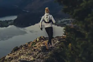 Trail running in autumn on the Jochberg on Lake Walchensee against the wonderful backdrop of the Alps