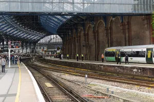 Train station with green train on the platform