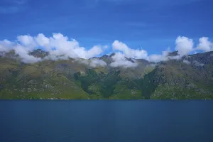 Tranquil landscape with mountains and a deep blue lake under a clear sky
