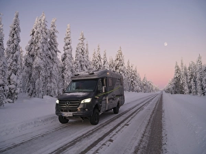 Category Scandinavia Prints: Travelling by motorhome in wintry Lapland at dawn