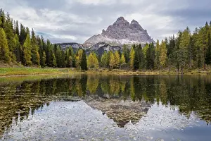 Tre Cime di Lavaredo peaks and Lake Antorno with sky reflection in calm water
