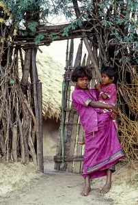 A tribal girl with her sister holding on her hip