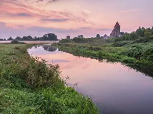 Tribsee with St. Thomas church on the river Trebel at dawn