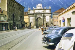 Triumphal arch in Maria-Theresien-Strasse street city centre of Innsbruck, Austria, Europe 1950s - cars parked outside Hotel Greif, Europe