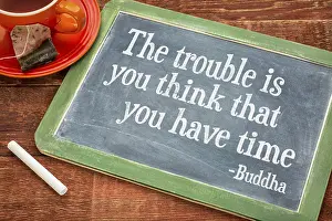 The trouble is you think that you have time- inspirational quote by Buddha on a slate blackboard with chalk