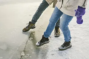 Trying the danger of the foot, testing the thin ice near the shore