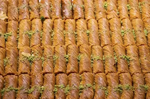 Turkish traditional dessert Kadayif baked in syrup served with nut powder