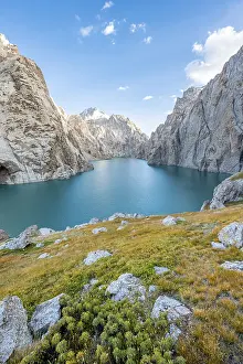 Turquoise mountain lake Kol Suu with rocky steep mountains