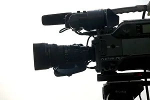 TV news video camera mounted on tripod doing shooting