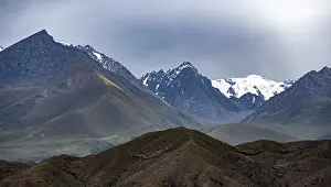 Twilight over snow-covered mountain peaks and steep slopes