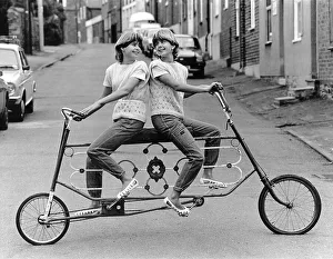 Twins on a curious bicycle, England, Great Britain