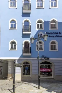 Typical building with rounded windows on a blue facade and characteristic street lamp in the old town