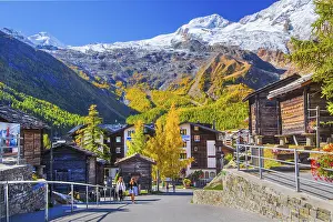 Typical granaries on the outskirts of the village with Allalin 4027m and Alphubel 4206m in autumn