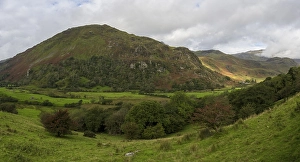 Typical landscape with mountains behind clouds in late summer