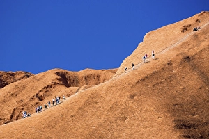 Category Mountain Landscapes Prints: Uluru, Australia, July 4, 2015: Climbers ascend Uluru against the wishes of the Aborginal land owners