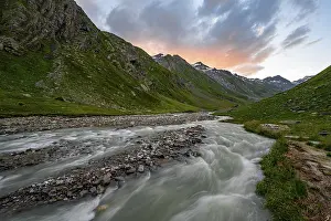 Umbaltal valley with Isel mountain stream at sunset