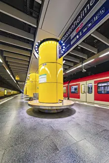 Underground station with striking yellow columns and urban ambience