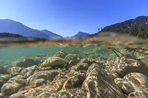 Underwater shot of river in front of mountains