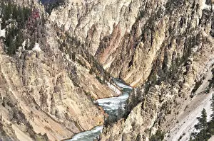 Unique rock structures flank a river inside the canyon