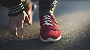 Unrecognizable man stopping lacing shoe outdoors