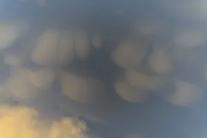 Unusual cloud structures create captivating shapes against a backdrop of warm colours as the sun sets