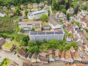 Urban scenario with renovated buildings and solar systems in green surroundings