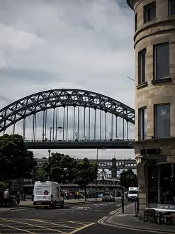 An urban scene with an arch bridge over a road