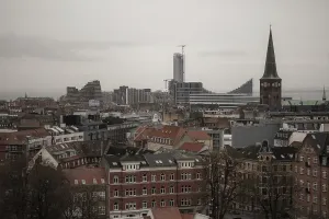 Urban skyline with historic and modern buildings under a gray sky