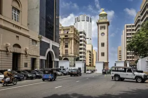 Framed Print : Urban street full of vehicles surrounded by modern and historic buildings under blue skies