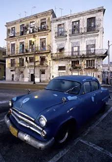 US-vintage car parking in front of crumbling facades