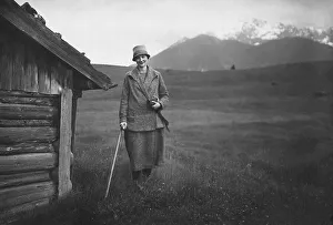 Vacation, woman with walking stick hiking in the Alps