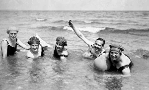 Vacation, four women and a man bathing in the sea
