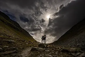 Val Minor with mountaineers in autumn colours with dramatic cloudy sky