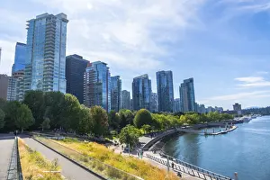 Framed Print : Vancouver's modern cityscape rises above a vibrant waterfront park