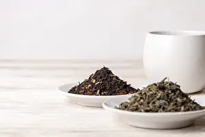 Varieties of black and green tea on a white background