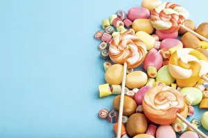 Various caramel candies on blue pastel background