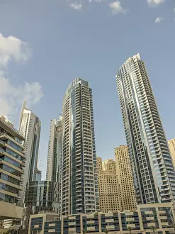 Various modern skyscrapers with glass facades rise into the sky
