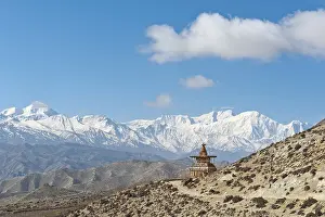 Vast landscape with stupa, the snow-covered mountains of the Annapurna Range at back