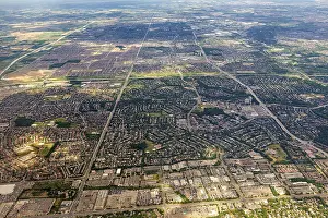 Vast urban areas with a distinctive striped pattern under a blue sky
