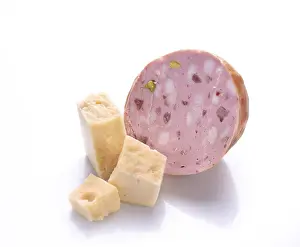 Veal sausage and pieces of cheese on a white background